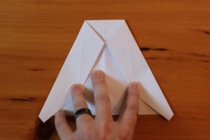 Papierowy samolot Złóż górne rogi w dół, tak aby ich punkty spotkały się w środkowym zagięciu.